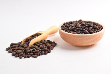 Coffee beans in wooden bowl isolated on white background