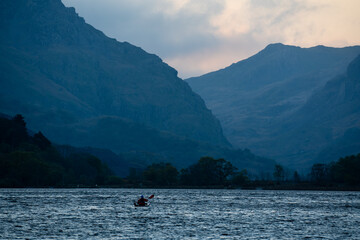 Single canoeist on mountain lake