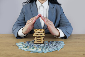 house covered of woman hands - insurance real estate concept