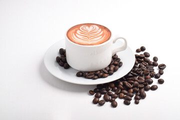 Cup of latte coffee and coffee beans isolated on white background