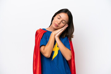 Super Hero caucasian woman isolated on white background making sleep gesture in dorable expression