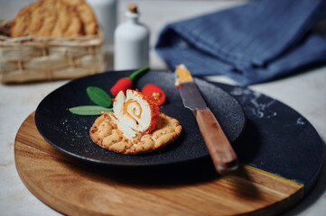 Rolled cream cheese with chili and pepper on crispbread