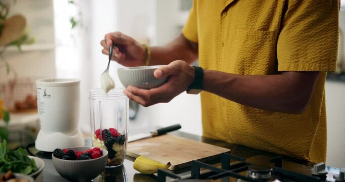 Man, hands and bowl with ingredients in blender for smoothie, healthy diet or meal prep in kitchen at home. Closeup, male person or nutritionist with organic food for drink, beverage or detox snack