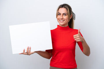 Young caucasian woman isolated on white background holding an empty placard with thumb up