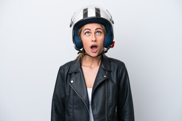 Young caucasian woman with a motorcycle helmet isolated on white background looking up and with surprised expression