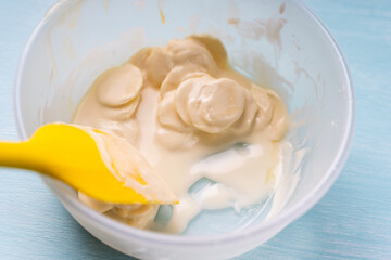 Tempering of white professional chocolate. The process of making handmade chocolates.