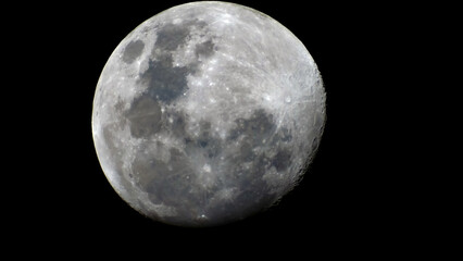 Full moon with craters and shadows visible against a black background.