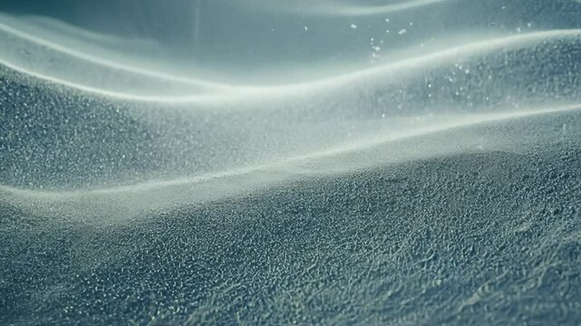 Slow motion video of white sand with cymatics patterns