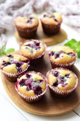 Sweet cupcakes with cherries for dessert. Delicious cupcakes with cherries for breakfast on a white background. Vertical photo. Close-up