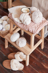 Knitted kids clothes, yarn and accessories for knitting. Needlework and knitting. Hobbies and creativity. Knit for children. Handmade. Christmas tree background