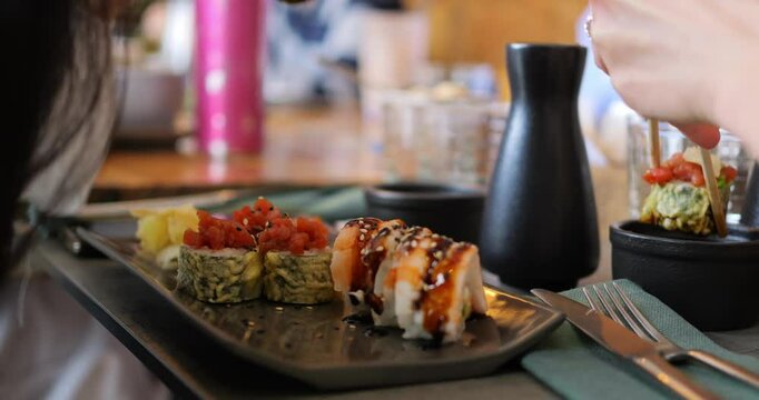 Business lunch in Japanese style. Japanese cuisine takes center stage during productive meeting. Sushi rolls on table add refined touch to professional setting, blending food and business seamlessly.