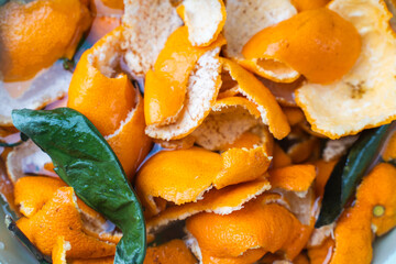 Tangerine zest or peels soaked in water for making candied fruit. Close-up. Background.