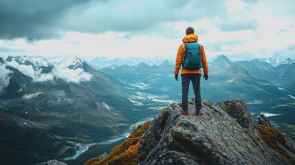 Stunning Summit Views of a Man Standing on Top of a Mountain Surrounded by Majestic Landscapes and Vibrant Skies Perfect for Adventure, Travel, and Outdoor Enthusiasts Stock Photography