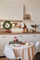 Christmas kitchen and table. Red, green and white decor christmas tree background. New Year celebration. Merry Christmas and Happy New Year.