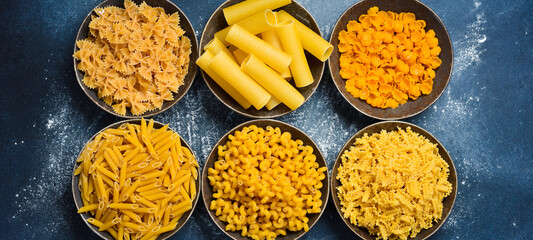 Various pasta in ceramic bowls. Cooking concept.