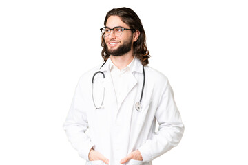 Fototapeta premium Young handsome man over isolated chroma key background wearing a doctor gown and with stethoscope