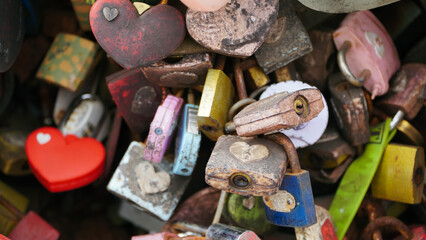 old rusty love locks on the bridge railing close up 