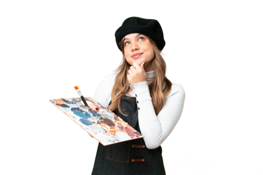 Young artist girl holding a palette over isolated chroma key background and looking up