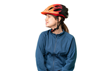 Young cyclist girl over isolated chroma key background looking side
