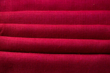 Fototapeta premium Close up Red fabric folded background texture.
