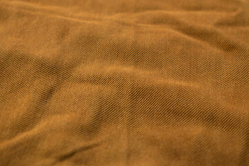 Detailed bright brown jeans fabric background texture.