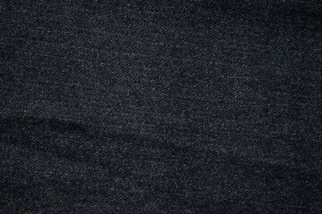 Flat view Dark grey jeans fabric texture background.