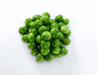 Close up of green peas grains isolated on white background