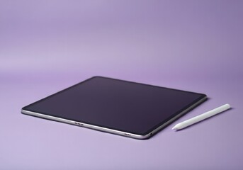 A tablet and stylus placed elegantly on a pastel purple background