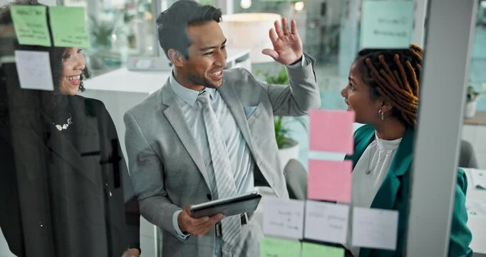 Meeting, high five and glass wall for success, planning and sticky notes with tablet for erp report. Man, women and celebration for business, teamwork or collaboration for partnership or b2b project