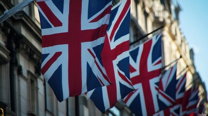 A row of British flags are flying outside a building