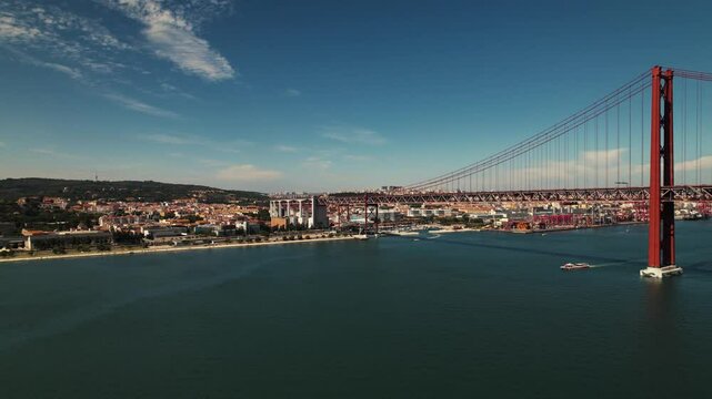  Bridge 25 de Abril in Lisbon, Portugal. Almada view of the Capital. flight over tejo side view