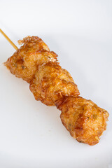 CLose-up view of chine food wanton fried ina white color plate with stick on it
