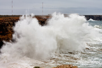 Cliffs hit by big waves. Dangerous surfing area. Portugal. Cape St. Vincent. Sagres. Beach for...