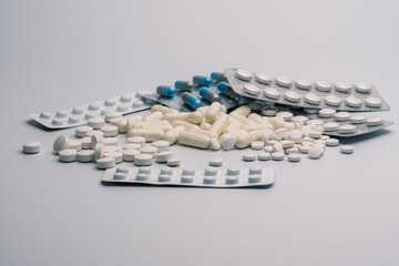 Assorted Pills and Capsules on a White Surface