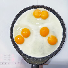 Cooking double-yolk eggs in a non-stick pan on a induction cooker stove