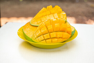 Ripe green and yellow mango fruit cut into pieces