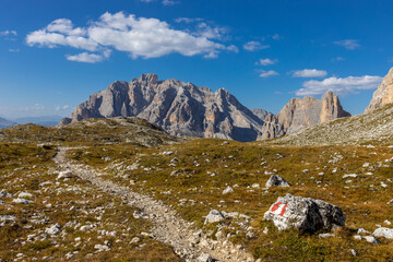 Fototapeta premium Autumn mountains. Alps in autumn colors. Dolomites beautiful yellow tree leaves autumn landscape. Alpine scenery of golden autumn