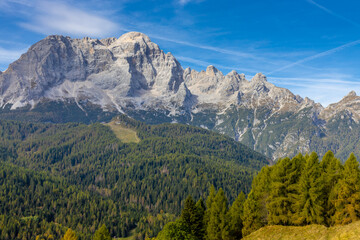 Fototapeta premium Autumn mountains. Alps in autumn colors. Dolomites beautiful yellow tree leaves autumn landscape. Alpine scenery of golden autumn