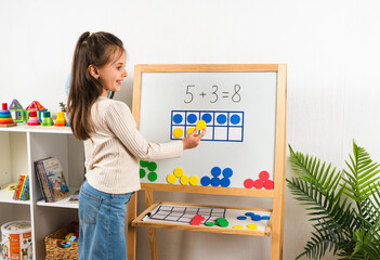 Girl Learning Math with Magnetic Frames and Counters