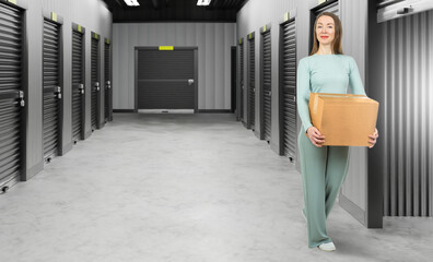 Woman rents storage unit. Girl with box near pantry. Corridor warehouse company. Owner of storage...