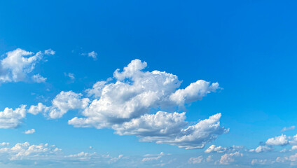 Beautiful Clouds Drift Across a Bright Blue Sky During a Sunny Day