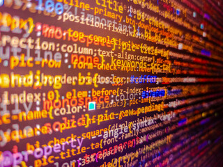 Developer working on program codes in office. Abstract background of digital binary code of software. Stock market ticker on monitor screen. Server failure and computer hacker attack.