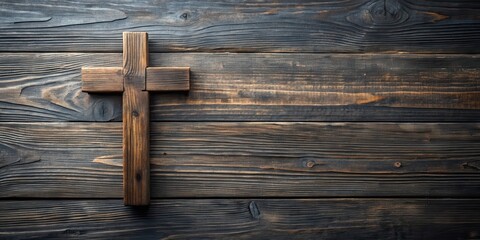 Rustic wooden cross on dark brown aged wood planks background