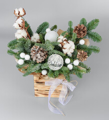 A traditional Christmas floral arrangement of green fir branches and flowers. New Year's decor for the interior