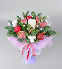 A traditional Christmas floral arrangement of green fir branches and flowers. New Year's decor for the interior