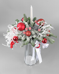 A traditional Christmas floral arrangement of green fir branches and flowers. New Year's decor for the interior