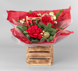 A traditional Christmas floral arrangement of green fir branches and flowers. New Year's decor for the interior