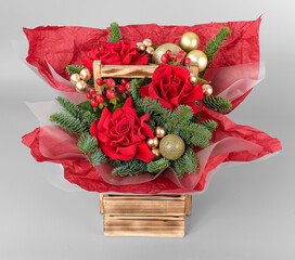 A traditional Christmas floral arrangement of green fir branches and flowers. New Year's decor for the interior