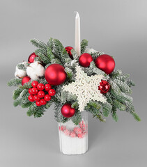 A traditional Christmas floral arrangement of green fir branches and flowers. New Year's decor for the interior
