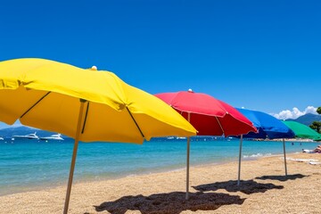 Fototapeta premium A sunny day at a beach on the French Riviera, with colorful umbrellas, sparkling water, and yachts in the background